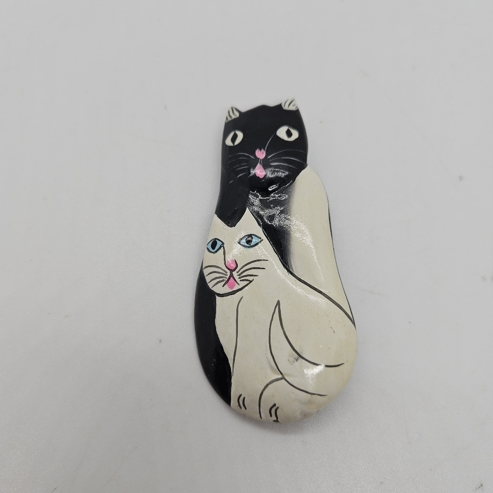 painted black and white wooden cats pin